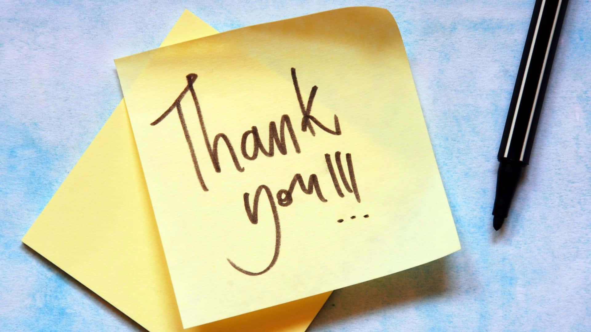 Yellow post it note with a hand written 'Thank You'